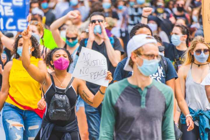 People marching in street protesting police violence