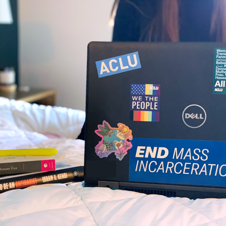 Person working on laptop with ACLU stickers